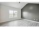 Bright bedroom featuring hardwood floors, high ceilings, and a large window allowing ample natural light at 2493 Oakleaf Rdg, Lithonia, GA 30058