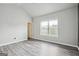 A bright bedroom offers hardwood floors, neutral walls and a large window at 2493 Oakleaf Rdg, Lithonia, GA 30058