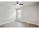 Empty room with gray laminate flooring, window and ceiling fan at 2493 Oakleaf Rdg, Lithonia, GA 30058