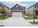 Charming two-story home featuring gray siding, a two-car garage and nicely manicured lawn at 2493 Oakleaf Rdg, Lithonia, GA 30058