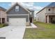 Charming two-story home featuring gray siding, a two-car garage and nicely manicured lawn at 2493 Oakleaf Rdg, Lithonia, GA 30058