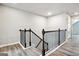 Hallway landing featuring hardwood floors, black metal railings, and neutral paint at 2493 Oakleaf Rdg, Lithonia, GA 30058