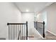Well-lit upper hallway with hardwood floors, black railings, and neutral colored walls at 2493 Oakleaf Rdg, Lithonia, GA 30058