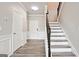 Welcoming entry features staircase with wood and iron trim, white doors, and wood-look floors at 2493 Oakleaf Rdg, Lithonia, GA 30058