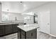 Bright kitchen showcasing an island with granite countertop and a view of the living area at 2493 Oakleaf Rdg, Lithonia, GA 30058