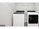 Modern laundry room features side-by-side washer and dryer and overhead shelving at 2493 Oakleaf Rdg, Lithonia, GA 30058