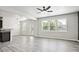 Bright and airy living room with modern light fixture and seamless flow to the kitchen at 2493 Oakleaf Rdg, Lithonia, GA 30058