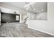Spacious living area with wood floors, modern lighting, seamlessly connected to the kitchen at 2493 Oakleaf Rdg, Lithonia, GA 30058