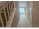 Hallway featuring tile flooring, a staircase, and neutral-toned walls at 3679 Seabass Rd, Decatur, GA 30034