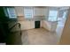 Bright open kitchen with white cabinets, granite counters and black appliances at 3679 Seabass Rd, Decatur, GA 30034