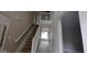 View of the staircase with white railings and landing with views to the living spaces at 3679 Seabass Rd, Decatur, GA 30034