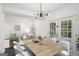 Dining area with modern light fixture and view to living area at 5490 Chemin De Vie, Sandy Springs, GA 30342