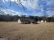 Spacious backyard showcasing the house's rear with a screened porch and shed at 120 Creekwood Ln, Fayetteville, GA 30214