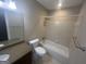 Bathroom with a tiled shower-tub, granite vanity, and a bright, clean aesthetic at 120 Creekwood Ln, Fayetteville, GA 30214