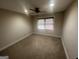 Standard bedroom with neutral carpet, a window, and a ceiling fan at 120 Creekwood Ln, Fayetteville, GA 30214