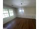 Bright dining room featuring wainscoting, luxury vinyl flooring, and modern light fixture at 120 Creekwood Ln, Fayetteville, GA 30214