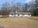 Charming single-story home with a well-maintained lawn and manicured landscaping at 120 Creekwood Ln, Fayetteville, GA 30214