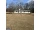Charming single-story home with a well-maintained lawn and manicured landscaping at 120 Creekwood Ln, Fayetteville, GA 30214