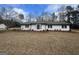 Charming single-story home with a well-maintained lawn and manicured landscaping at 120 Creekwood Ln, Fayetteville, GA 30214