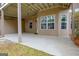 Spacious covered back patio features a concrete floor and multiple windows for ample light at 135 Edgewater Trl, Fayetteville, GA 30215