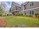 Beautiful backyard featuring lush greenery and a charming patio area with a fan at 135 Edgewater Trl, Fayetteville, GA 30215