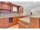 Close up of a basement bar featuring wine cooler, granite countertops, and wood cabinets at 135 Edgewater Trl, Fayetteville, GA 30215
