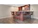 Basement bar area featuring wood cabinets, granite countertop, and seating for four at 135 Edgewater Trl, Fayetteville, GA 30215