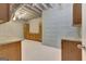 Unfinished basement kitchen area with wooden cabinets, granite countertops and exposed ductwork at 135 Edgewater Trl, Fayetteville, GA 30215