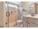 Bathroom with a glass enclosed shower, neutral tile and vanity with decorative mirror at 135 Edgewater Trl, Fayetteville, GA 30215