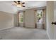Neutral bedroom with ceiling fan, carpeted floors, and natural light from the windows at 135 Edgewater Trl, Fayetteville, GA 30215