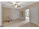 Spacious carpeted bedroom with neutral walls, ceiling fan and doorway to the next room at 135 Edgewater Trl, Fayetteville, GA 30215