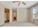 Carpeted bedroom with neutral walls, ceiling fan, one window and attached bathroom at 135 Edgewater Trl, Fayetteville, GA 30215