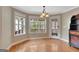 Bright dining area with hardwood floors, multiple windows, and a door leading to the outdoor space at 135 Edgewater Trl, Fayetteville, GA 30215