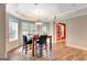 Breakfast nook features wood floors, modern chandelier, and a table set for four at 135 Edgewater Trl, Fayetteville, GA 30215