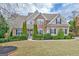 Traditional two-story home with well-manicured lawn and mature landscaping at 135 Edgewater Trl, Fayetteville, GA 30215