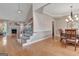 Inviting foyer with hardwood floors, stairs leading to the upper level, and a view into the dining room at 135 Edgewater Trl, Fayetteville, GA 30215