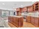 Spacious kitchen featuring a large island, granite countertops, and stainless steel appliances at 135 Edgewater Trl, Fayetteville, GA 30215