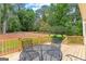 Wood deck overlooking landscaped backyard and features a wrought iron chair set at 108 Summit Walk, Peachtree City, GA 30269