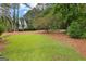 Manicured backyard, pine straw and lush trees create a private oasis at 108 Summit Walk, Peachtree City, GA 30269