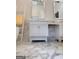 Elegant bathroom featuring marble floors, white vanity, and decorative ladder for towels at 108 Summit Walk, Peachtree City, GA 30269