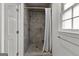 Modern bathroom features a tile shower, glass door, and a bright window at 108 Summit Walk, Peachtree City, GA 30269