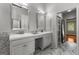 Bright bathroom with marble floors, double vanity, and a framed mirror above each sink at 108 Summit Walk, Peachtree City, GA 30269