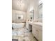 Luxurious bathroom with soaking tub, dual vanities, marble accents and a chandelier at 108 Summit Walk, Peachtree City, GA 30269
