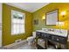 Quaint bathroom with large mirror, granite countertop, and window providing natural light for a comforting and stylish space at 108 Summit Walk, Peachtree City, GA 30269