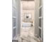 Stunning bathroom features a soaking tub, marble floors, and a glamorous chandelier at 108 Summit Walk, Peachtree City, GA 30269
