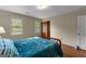 Bedroom with wood floor, paneled door and two windows at 108 Summit Walk, Peachtree City, GA 30269
