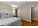 Bedroom featuring a wood floor, nightstand, and view to closet at 108 Summit Walk, Peachtree City, GA 30269
