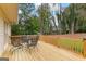 Outdoor wood deck featuring a wrought iron table and chair set at 108 Summit Walk, Peachtree City, GA 30269