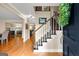 Bright entryway with hardwood floors, elegant staircase and a glimpse of the dining room at 108 Summit Walk, Peachtree City, GA 30269