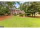 Two-story brick home with mature trees and landscaping in a tranquil setting at 108 Summit Walk, Peachtree City, GA 30269